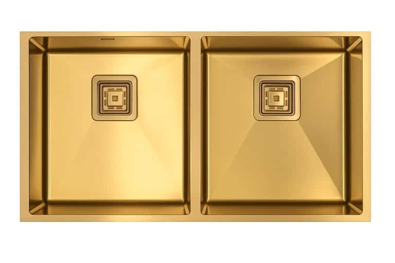 Luxury gold kitchen sink with dual basins and modern square drain designs for high-end kitchen remodels and premium cooking spaces.